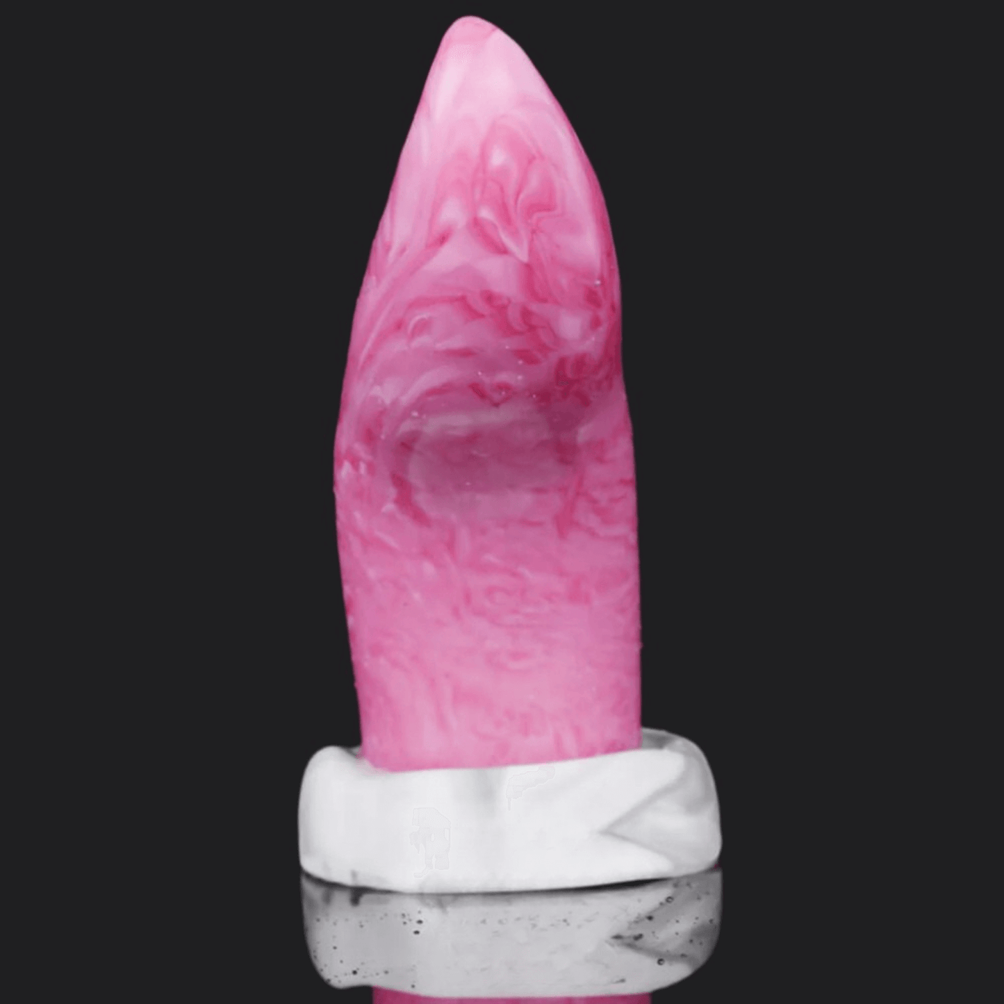 Vibrantly colored dragon dildo displayed next to a clear block, showcasing unique design and detail.