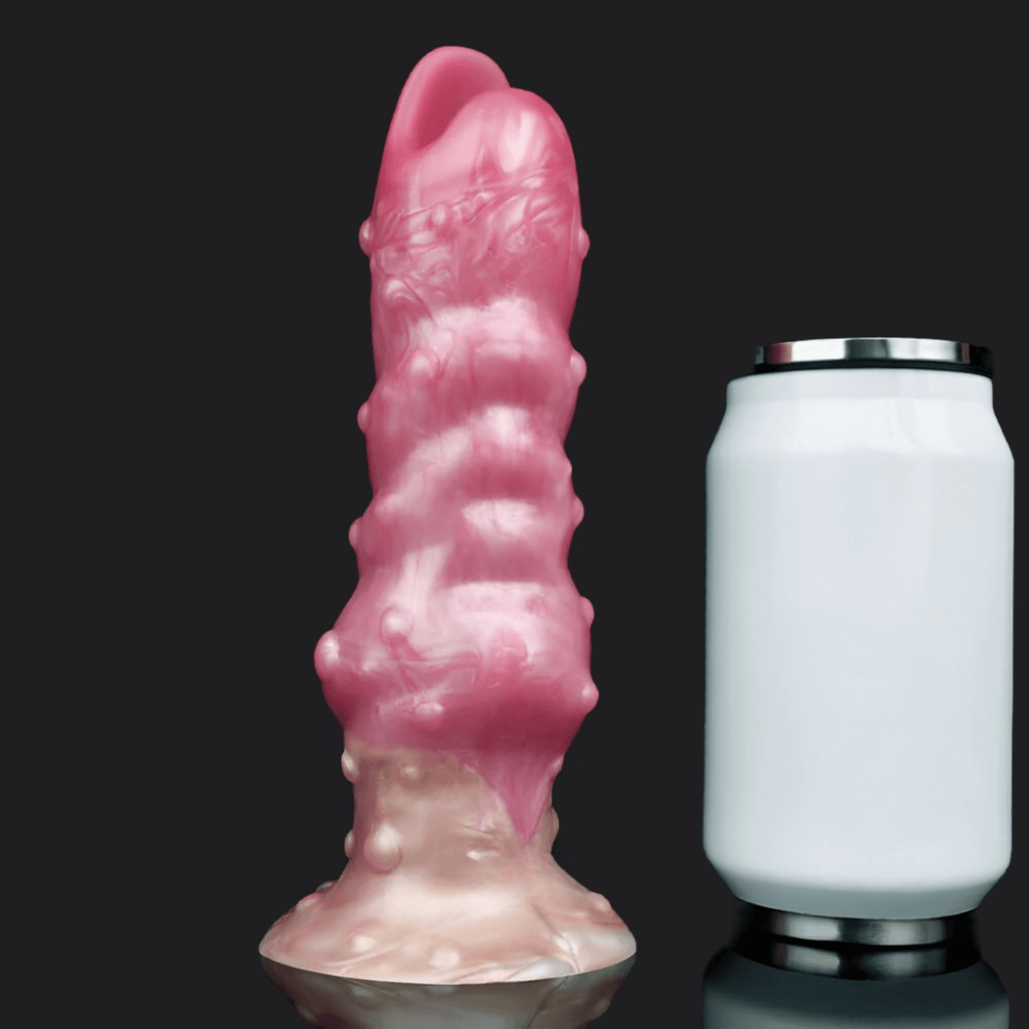 Yautja Ovipositor Alien Dildo in pink silicone next to a standard beer can for size comparison.