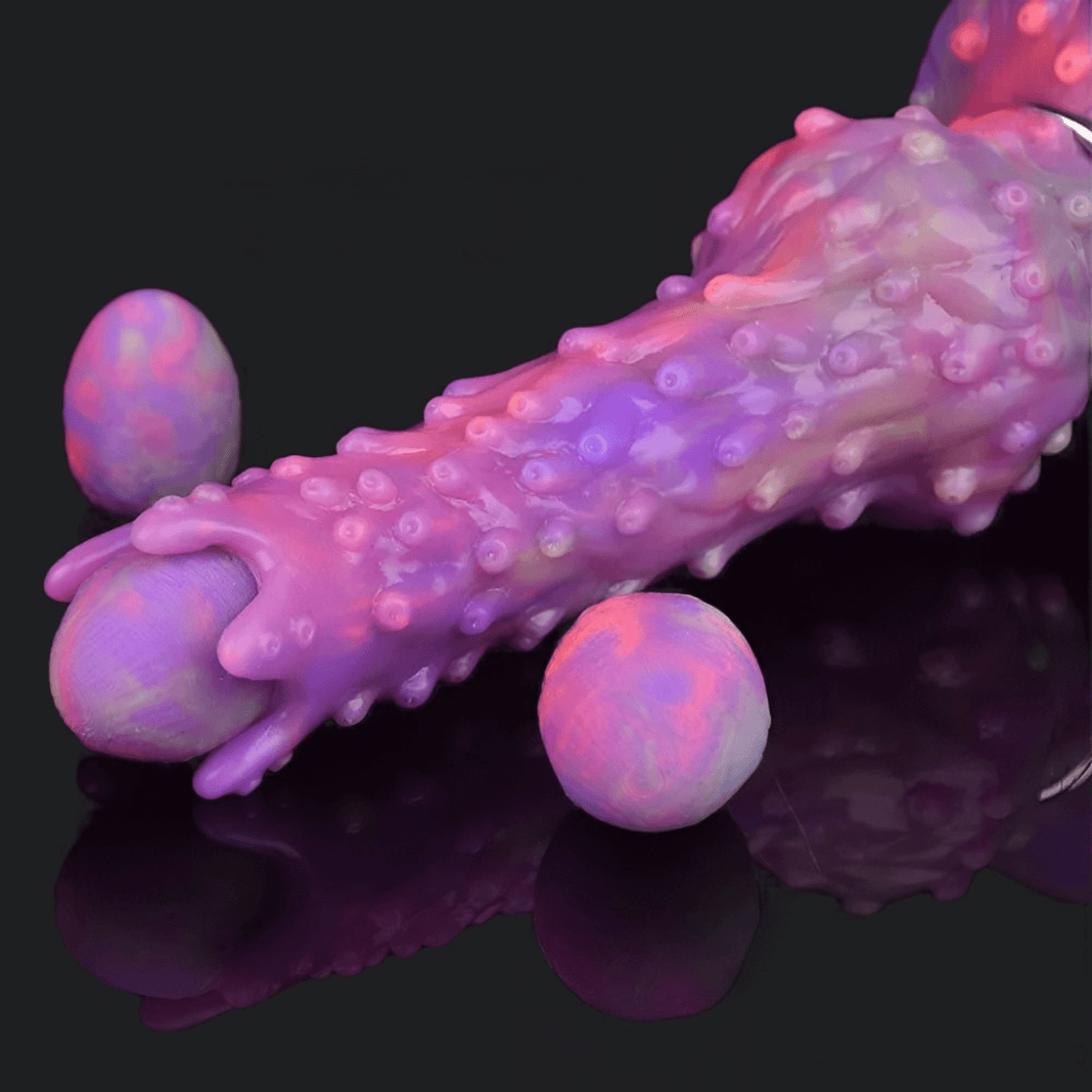 Neomorph Ovipositor Alien Dildo in vibrant purple and pink colors with textured surface and accompanying eggs.