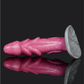 Dragon Dildo Scylla in pink with gill-like flared shaft and pointed head, reflecting on a dark surface.